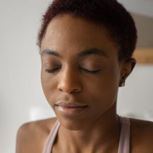 close up photo of a woman meditating with her eyes closed